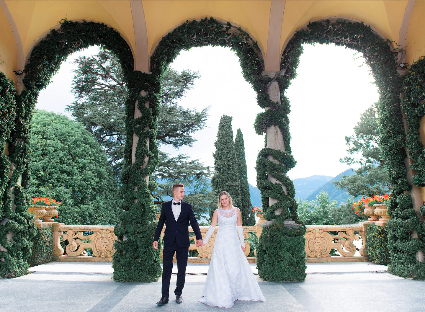 Bride and groom on the villa's flowery porch