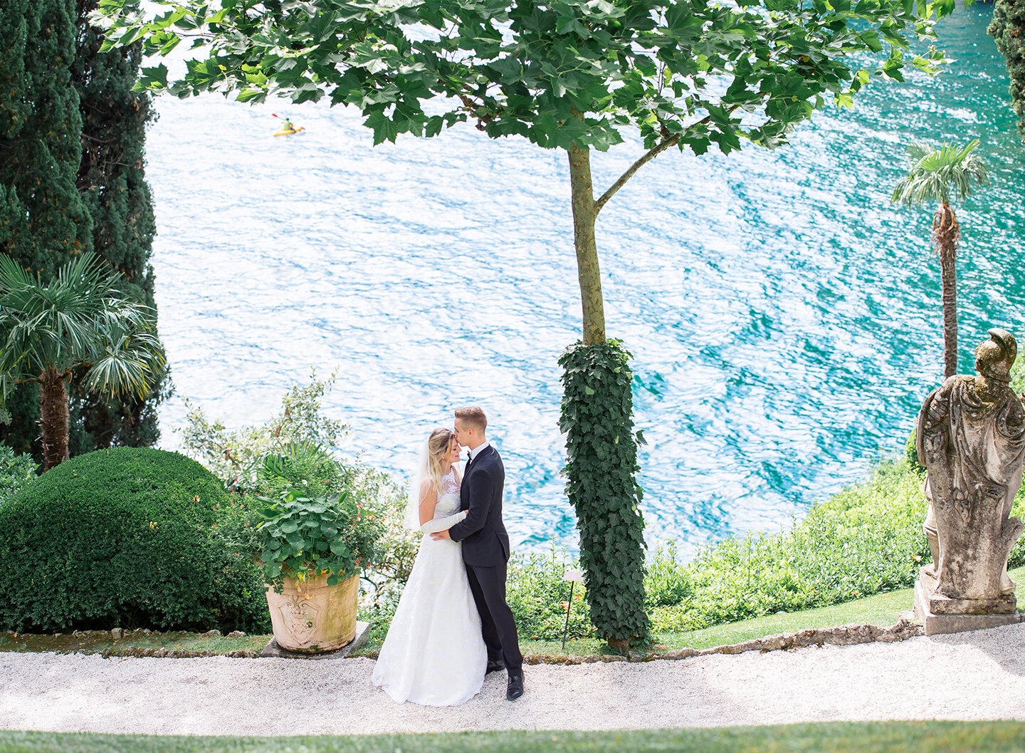 Bride and groom kissing in front of the lake
