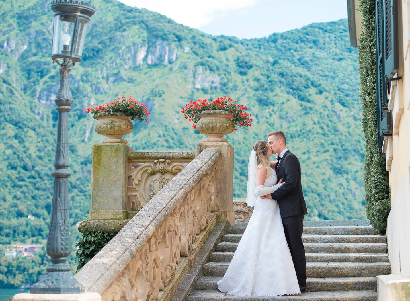Bride and groom kissing on a stairway